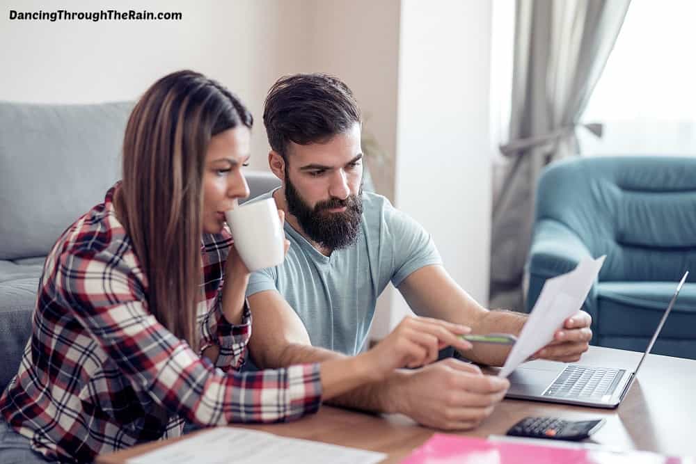 A couple sitting at a table figuring out their budget