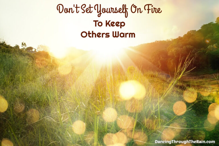 A field with the sun shining on it with the words Don't Set Yourself On Fire To Keep Others Warm