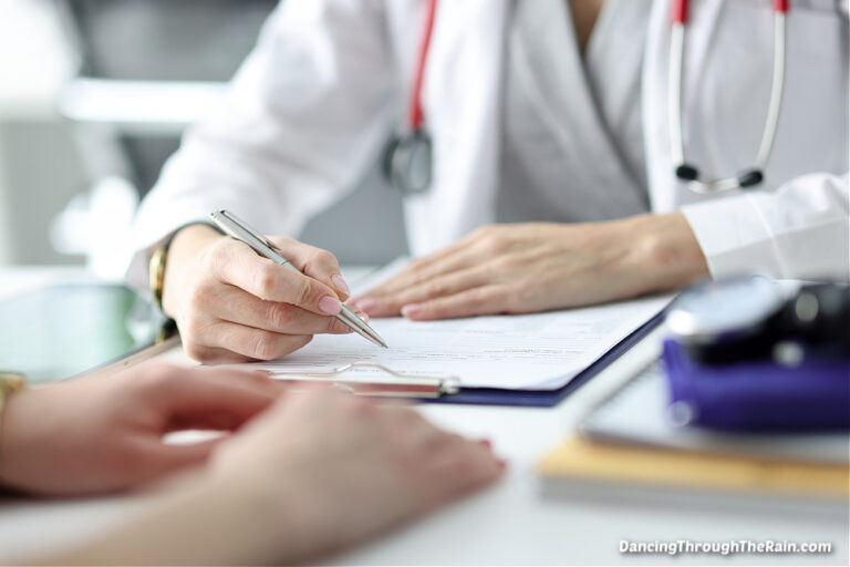 A doctor in a white coat sitting at a table with a patient