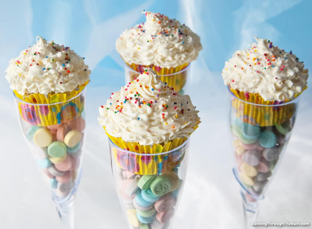 Four Champagne Glass Cupcakes with visible candy inside the glasses