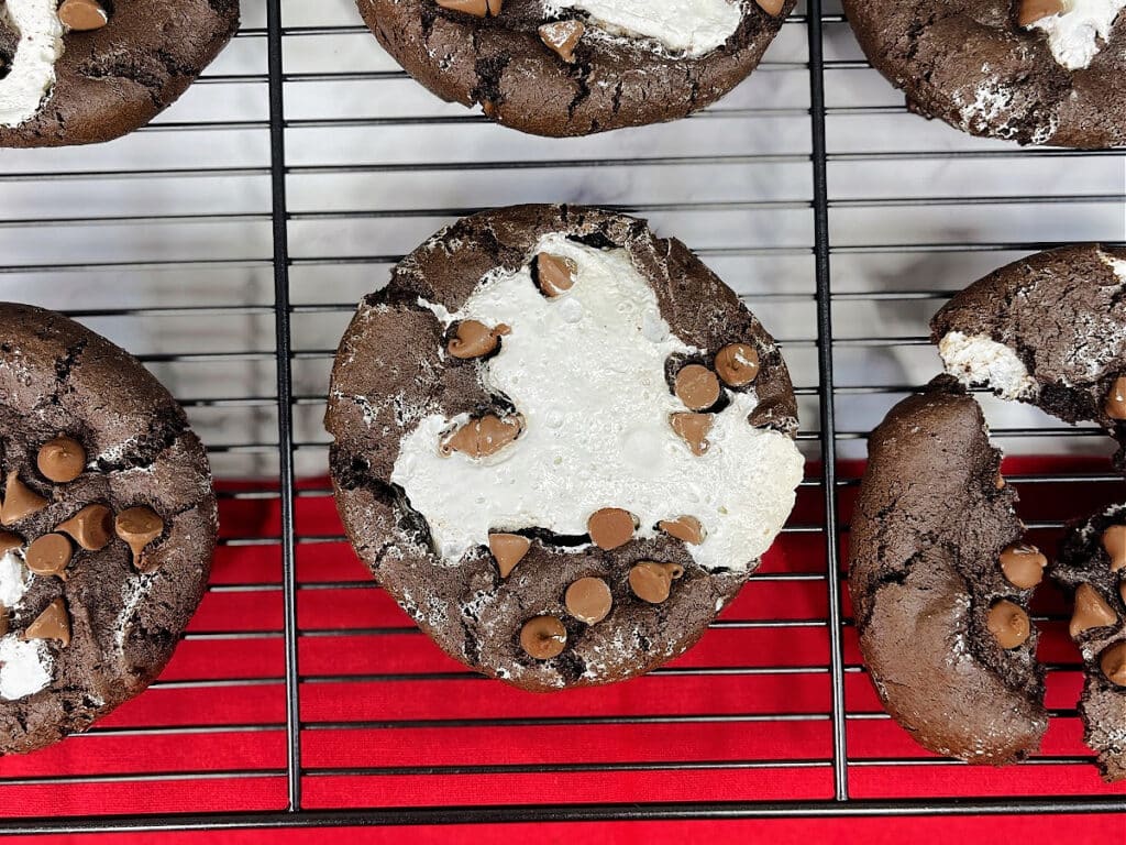 Six Chocolate Marshmallow Cookies on a wire rack above a red placemat